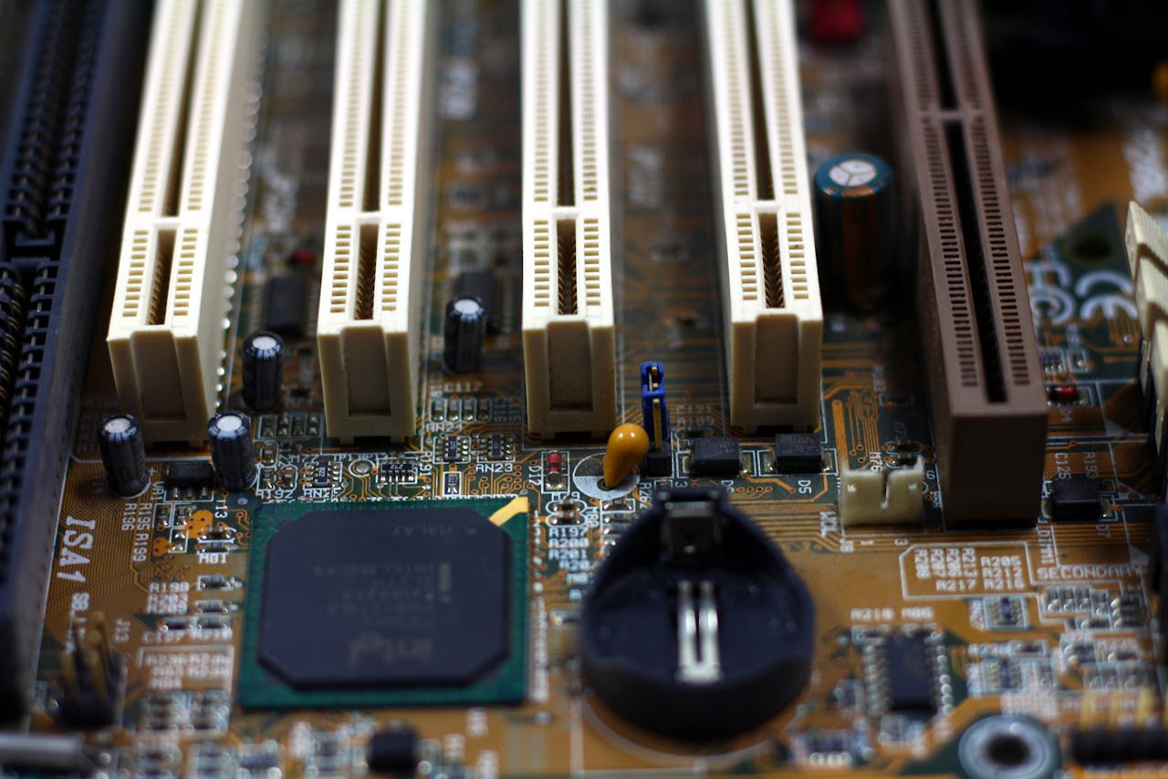 about-img Detailed close-up of computer motherboard showing components like RAM slots and capacitors.