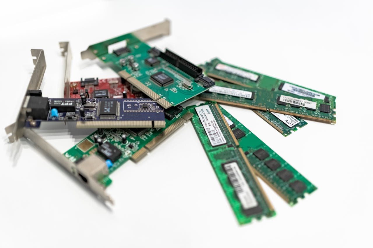 our-experience A detailed close-up of computer RAM sticks and PCI cards arranged on a white surface for tech illustration.